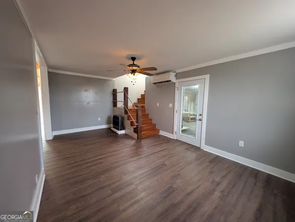a view of a room with wooden floor