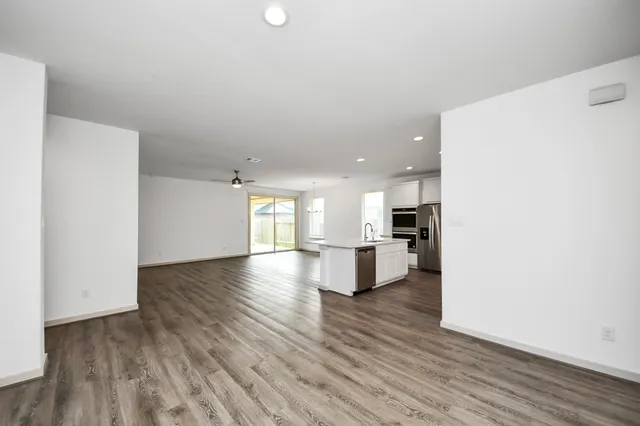 a view of kitchen with refrigerator and window