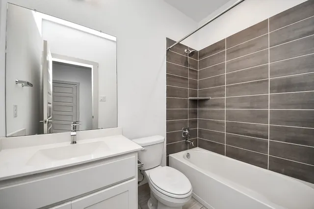 a bathroom with a toilet a sink and bathtub