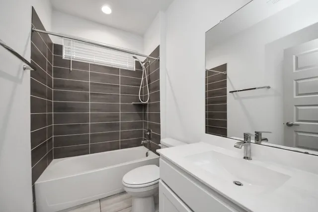 a bathroom with a sink mirror toilet and bathtub
