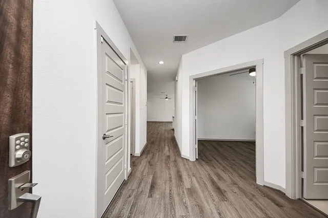 a view of hallway with wooden floor