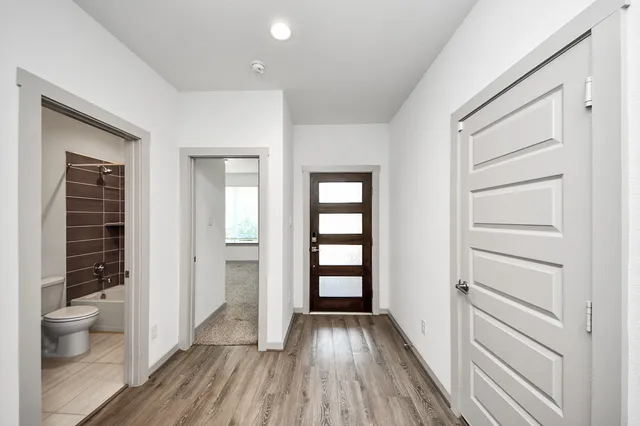 a view of bathroom with a toilet and a hardwood