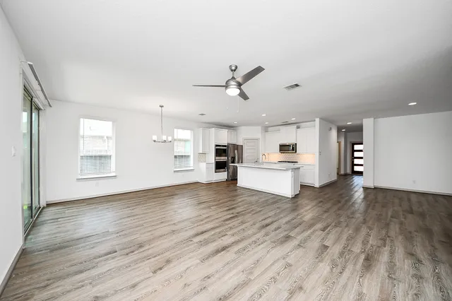 a view of a kitchen with wooden floor and a kitchen