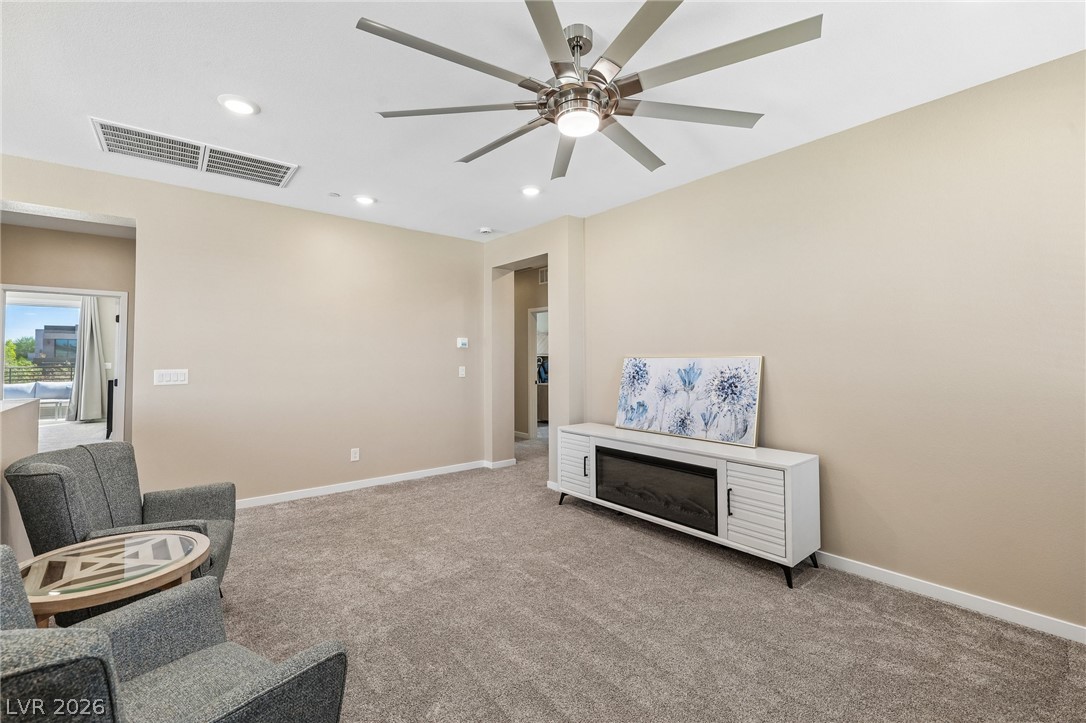 194 Viento Ridge Street Henderson, NV 89012 - Photo 27 of 72 Recessed lighting and soft carpeting create a cozy ambiance in this inviting living space.