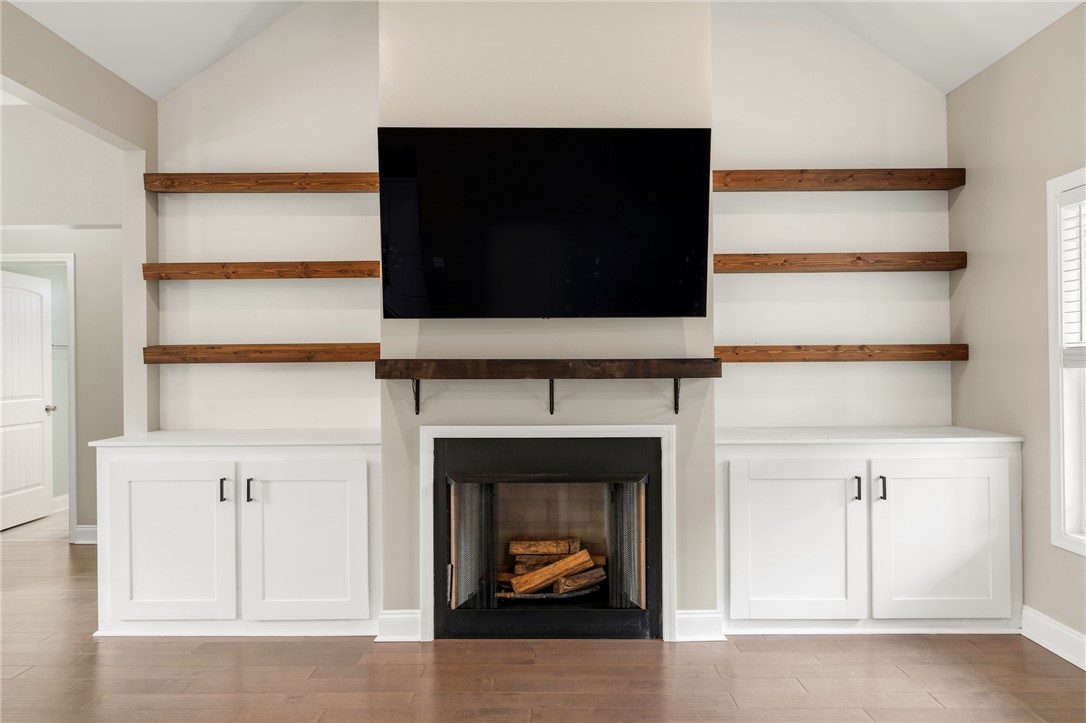 1411 Dunn Road Anderson, SC 29625 - Photo 6 of 30 This inviting living area features a warm fireplace, custom built-ins, and vaulted ceilings.