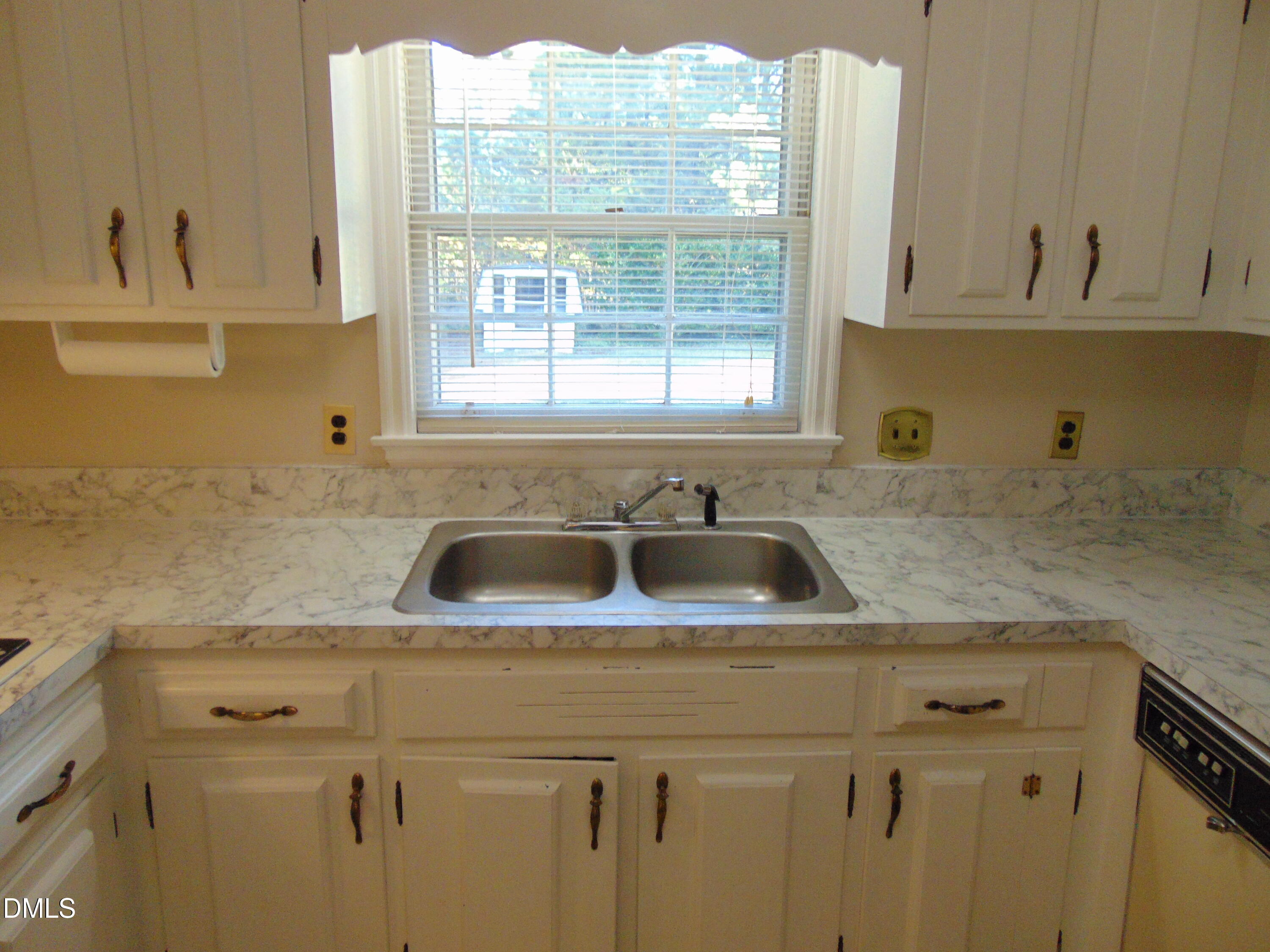 3108 Ridgecrest Drive Rocky Mount, NC 27803 - Photo 14 of 55 a kitchen with sink a window and cabinets