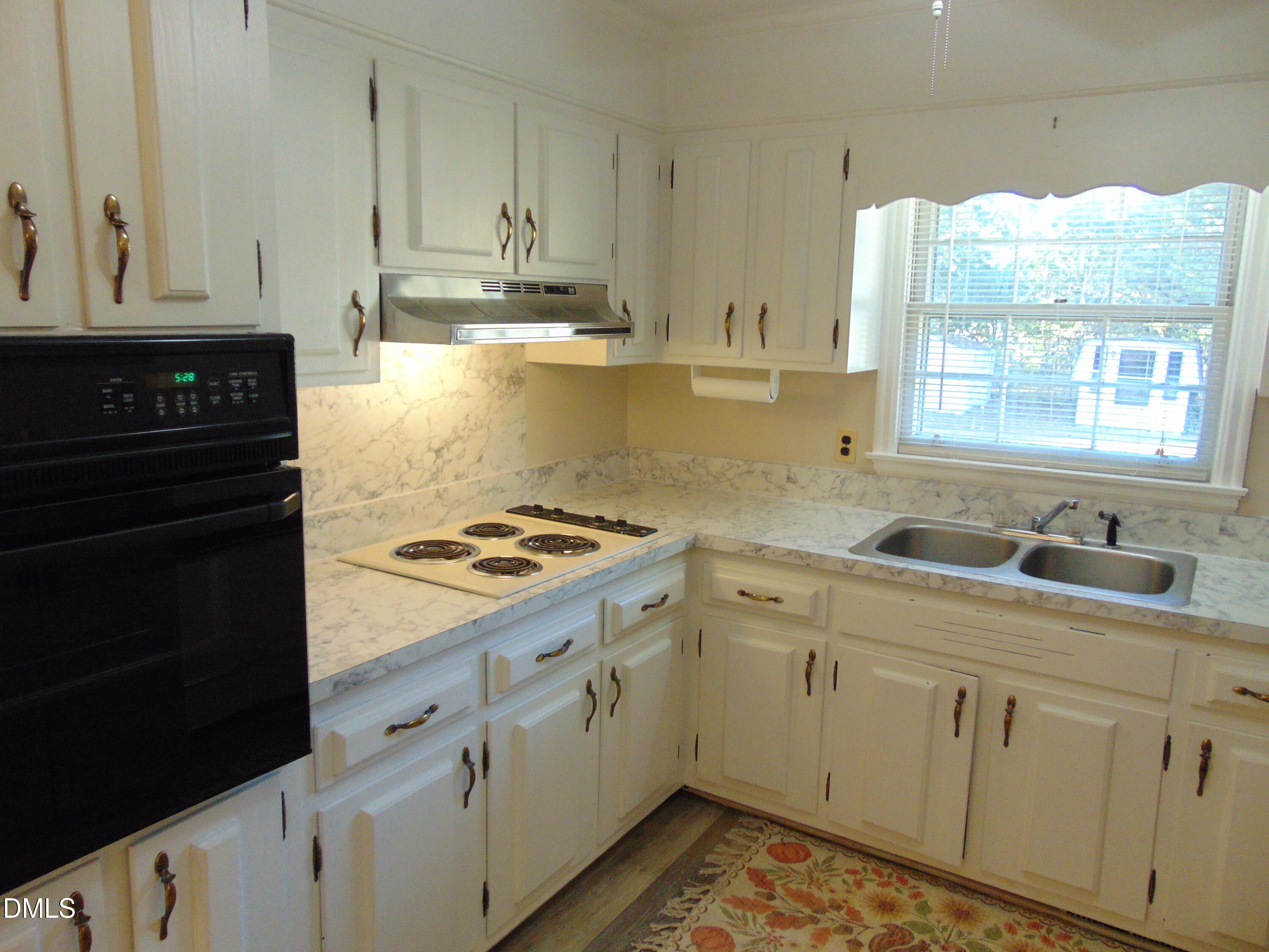 3108 Ridgecrest Drive Rocky Mount, NC 27803 - Photo 15 of 55 a kitchen with granite countertop a stove a sink and white cabinets