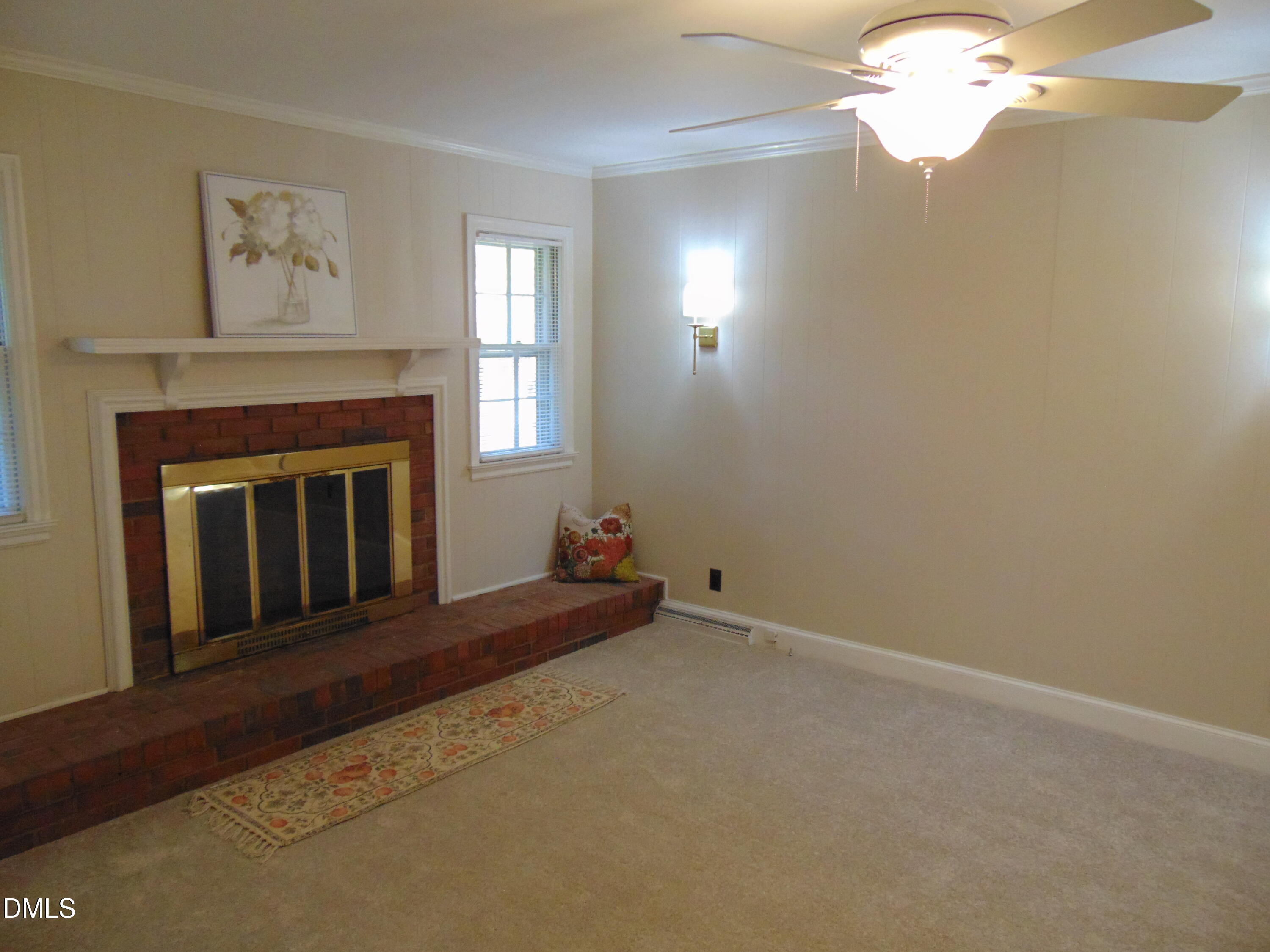 3108 Ridgecrest Drive Rocky Mount, NC 27803 - Photo 21 of 55 a living room with a fireplace and a chandelier