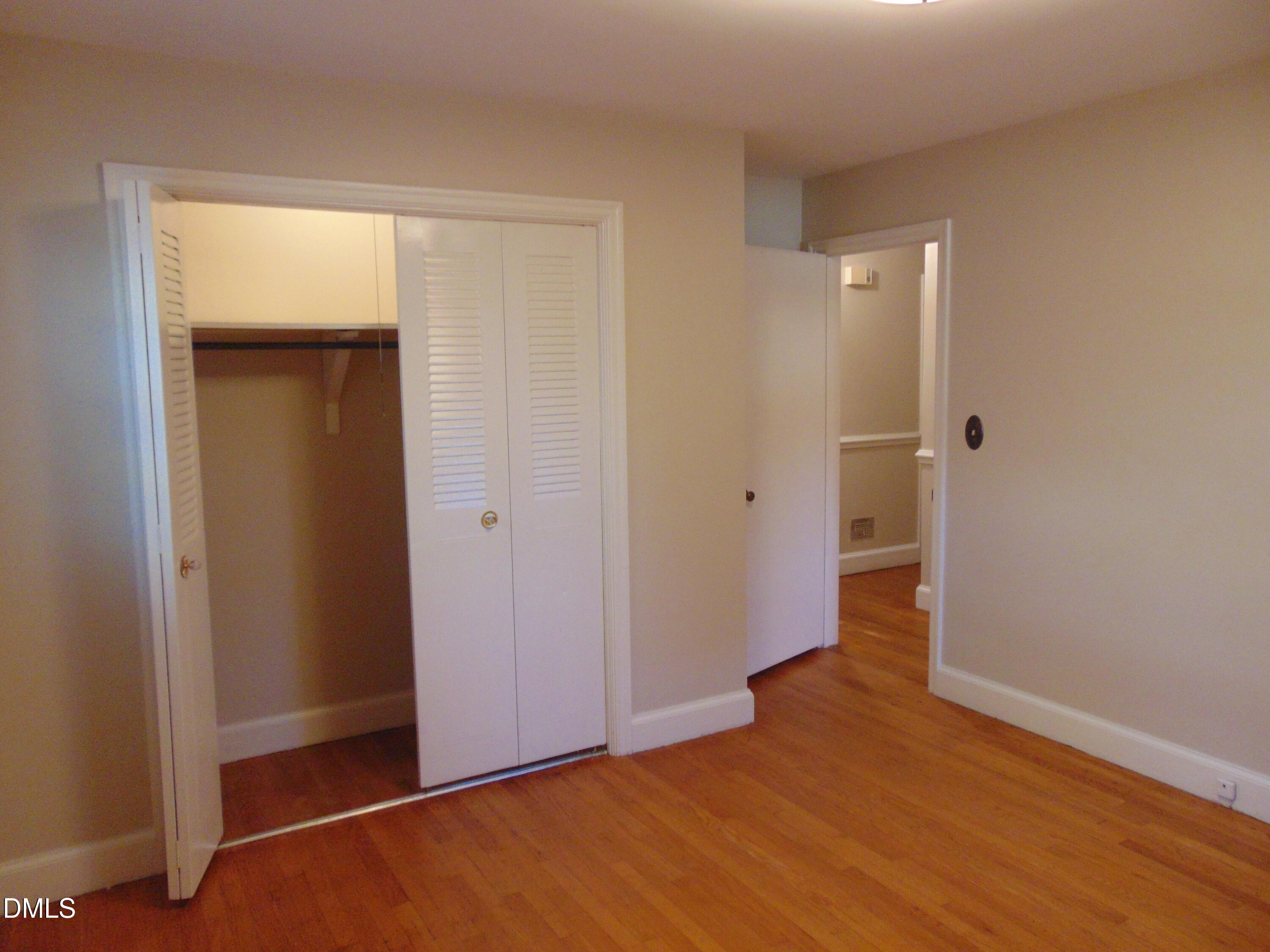 3108 Ridgecrest Drive Rocky Mount, NC 27803 - Photo 38 of 55 an empty room with closet and wooden floor