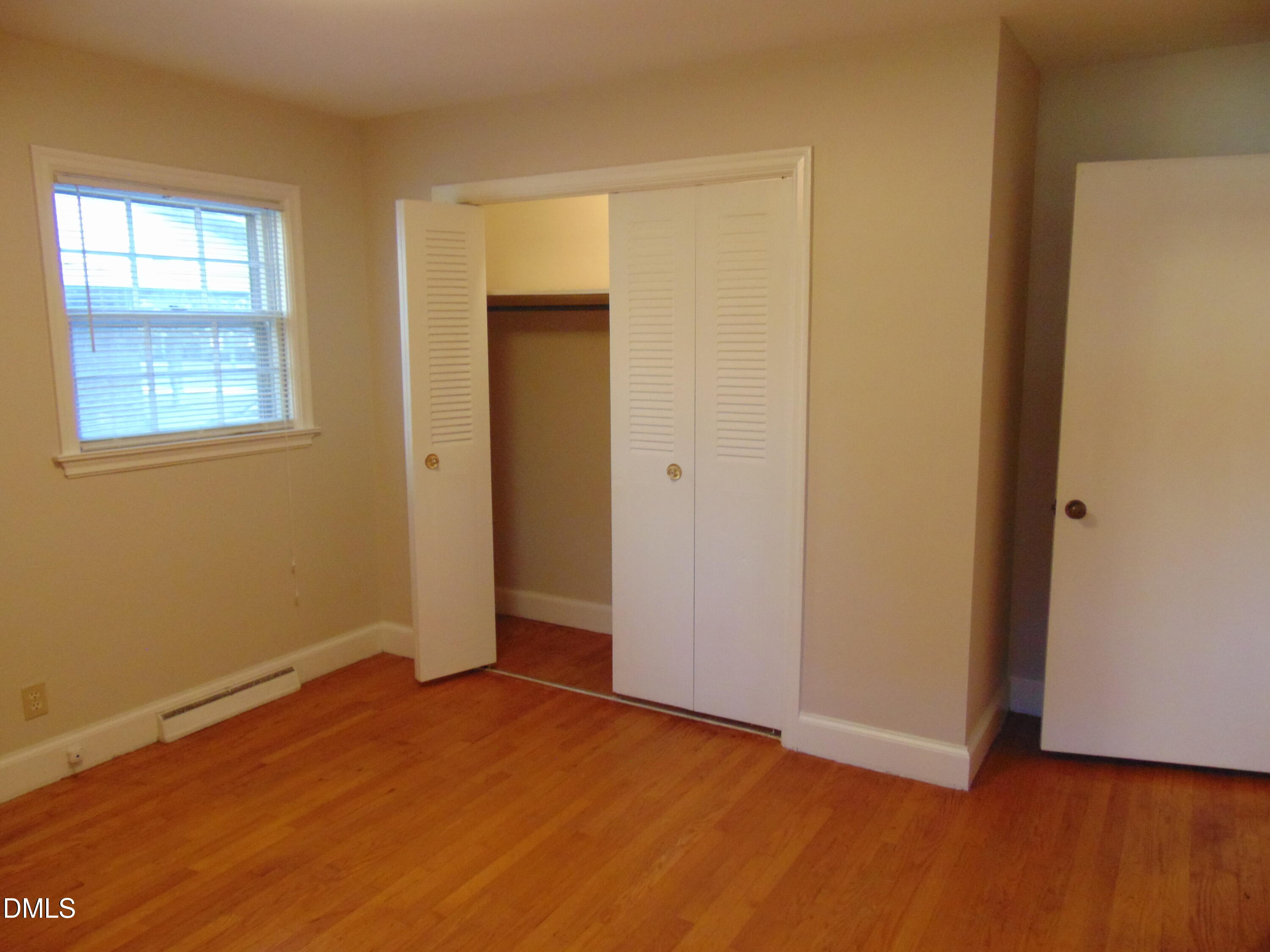 3108 Ridgecrest Drive Rocky Mount, NC 27803 - Photo 39 of 55 a view of an empty room with wooden floor and a window