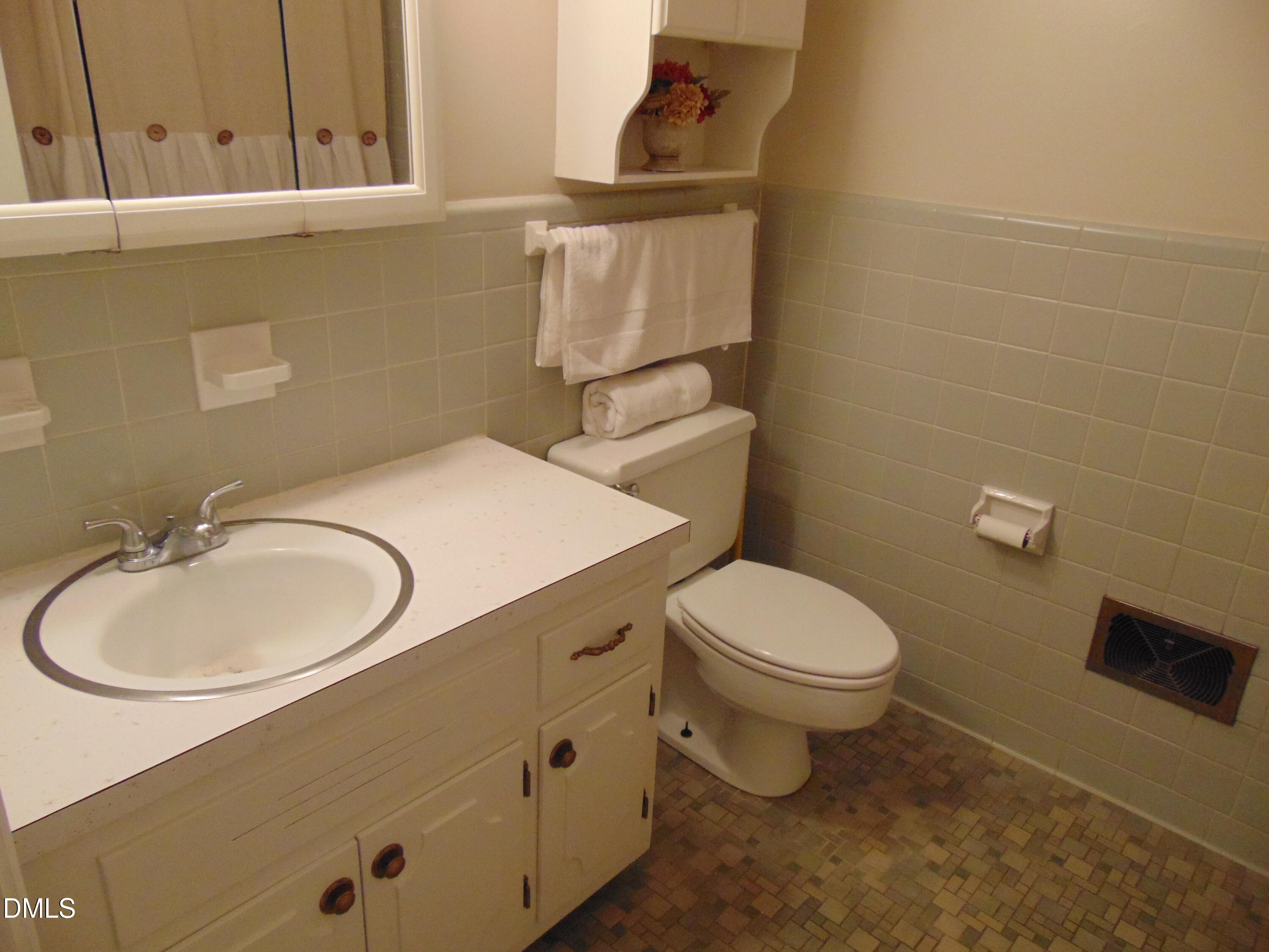 3108 Ridgecrest Drive Rocky Mount, NC 27803 - Photo 43 of 55 a bathroom with a sink a toilet and a mirror