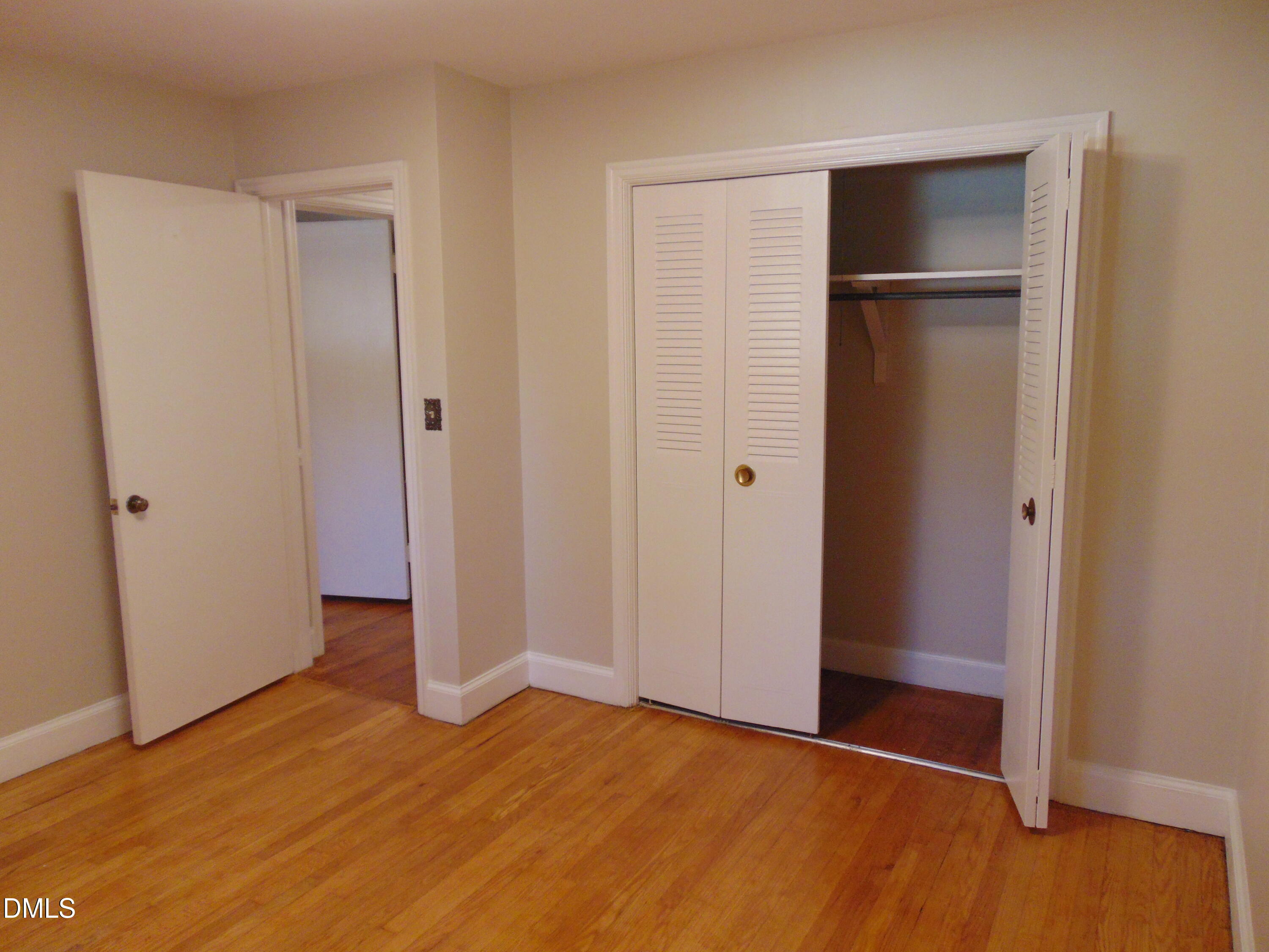 3108 Ridgecrest Drive Rocky Mount, NC 27803 - Photo 45 of 55 a view of an empty room with closet and wooden floor