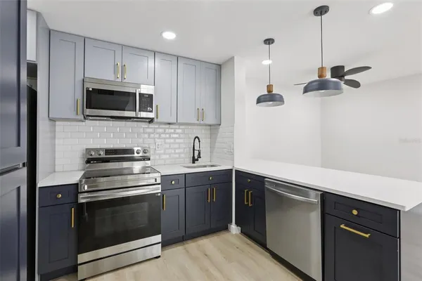 a kitchen with a sink stove and microwave