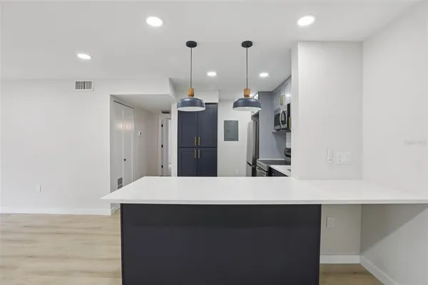 a kitchen with a refrigerator and a sink
