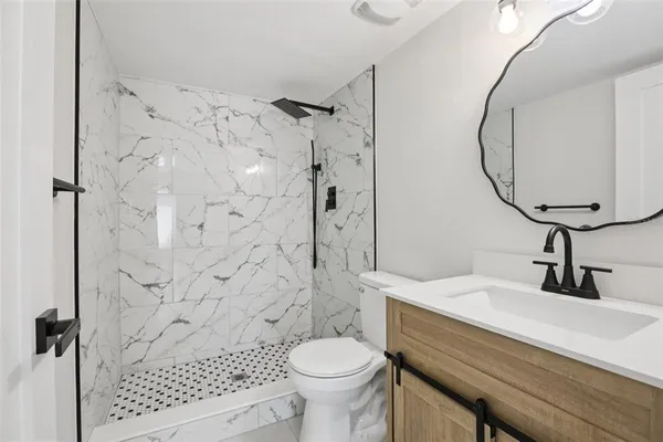 a bathroom with a sink toilet and shower