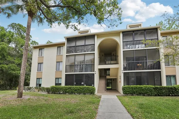 a front view of a house with a garden and plants