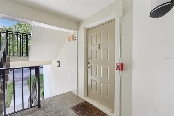 a view of a hallway with a door and stairs