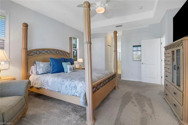 a bedroom with a bed a flat screen tv and dresser