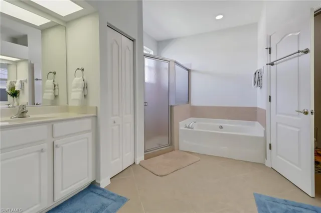 a bathroom with a bathtub shower and a sink