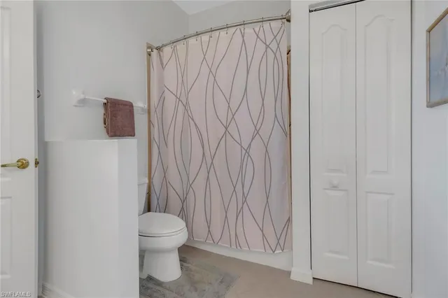 a bathroom with a toilet and a shower