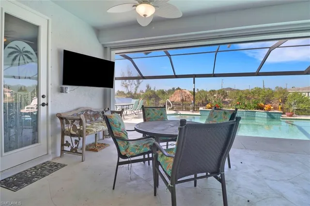 a dining room with furniture and a floor to ceiling window