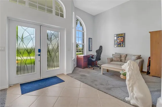 a living room with furniture and a floor to ceiling window