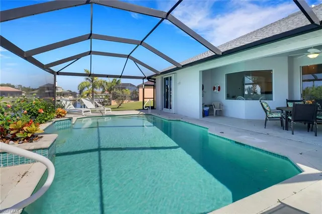 a view of a backyard with plants and patio
