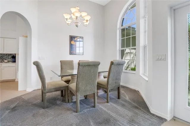 a view of a dining room with furniture and chandelier