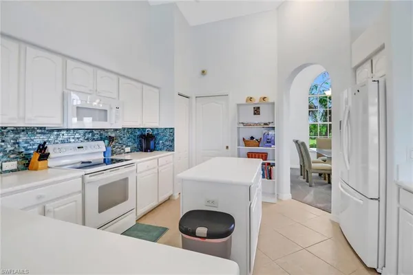 a kitchen with a white stove top oven and refrigerator