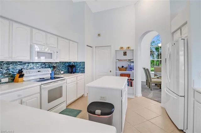 a kitchen with a white stove top oven and refrigerator