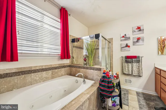 a bathroom with a bathtub and a shower