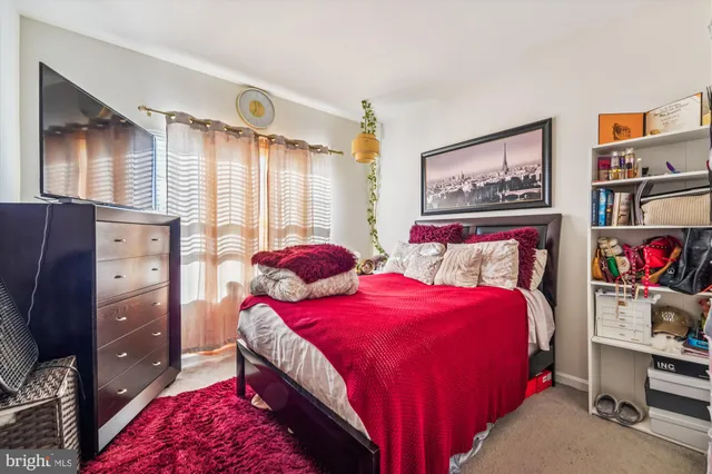 a bedroom with a bed and a dresser in it