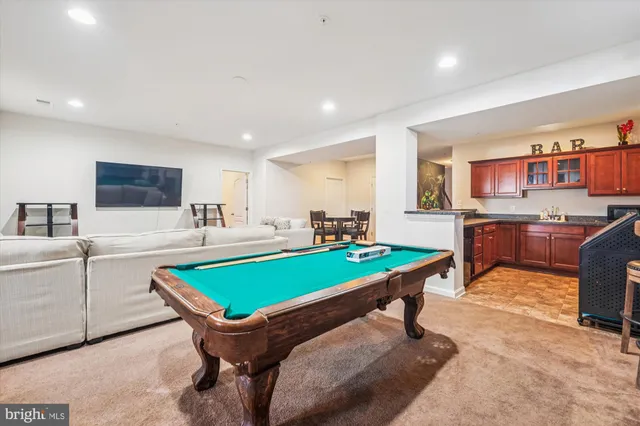 a room with furniture pool table and flat screen tv