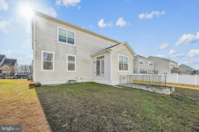 a view of a house with a yard and sitting area