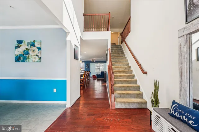 a view of entryway and hall with wooden floor