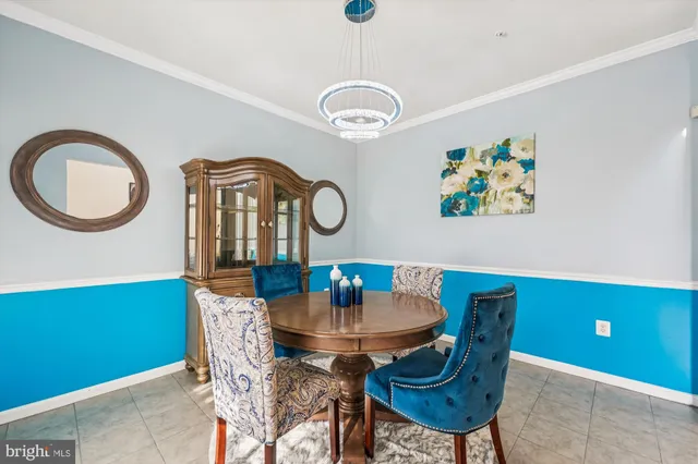 a view of a dining room with furniture and a chandelier