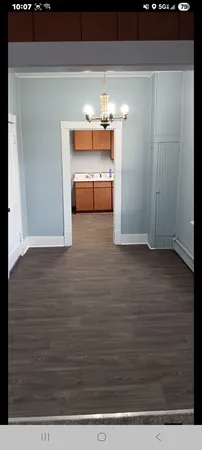 a view of a room with wooden floor