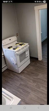 a utility room with wooden floor