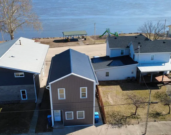 an aerial view of a house with a yard