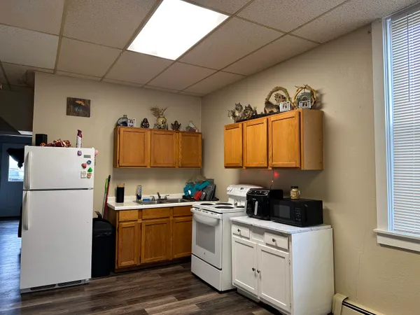 a kitchen with a refrigerator a stove a microwave and cabinets