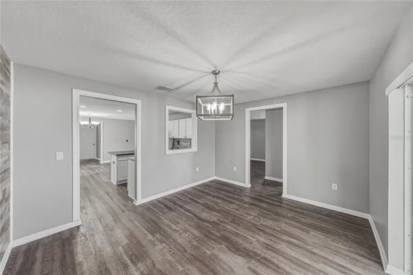a view of an empty room and wooden floor