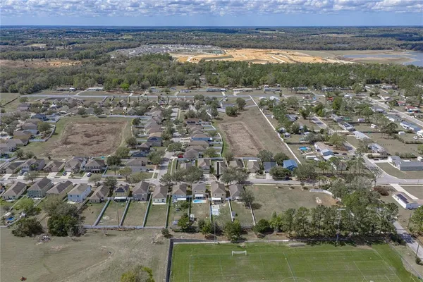 an aerial view of a house with a yard