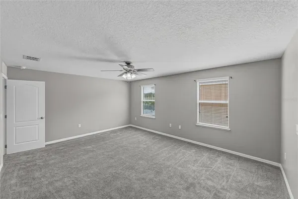a view of a livingroom with a ceiling fan and window