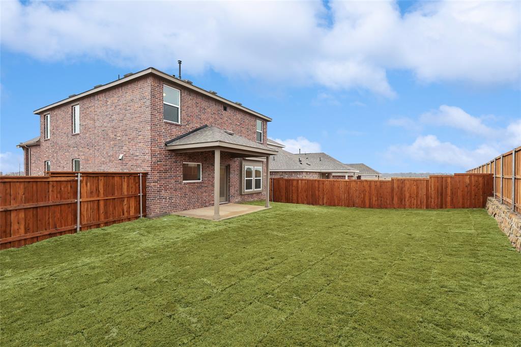 3900 Coco Lane Sherman, TX 75090 - Photo 25 of 40 Rear view of property with a yard and a patio area