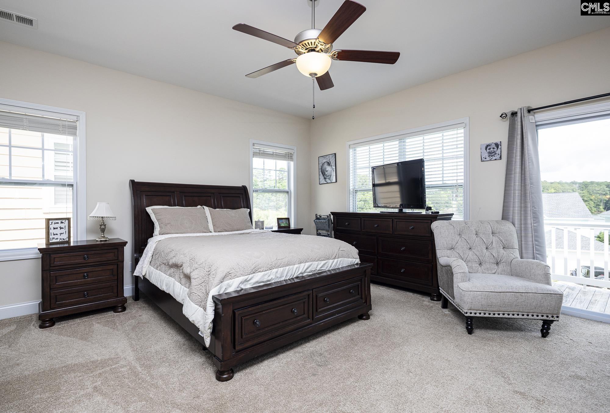 213 Sunset Point Drive Lexington, SC 29072 - Photo 18 of 35 a spacious bedroom with a bed and a couch