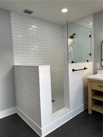 a bathroom with a shower and a sink