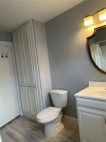 a bathroom with a toilet a sink and a mirror