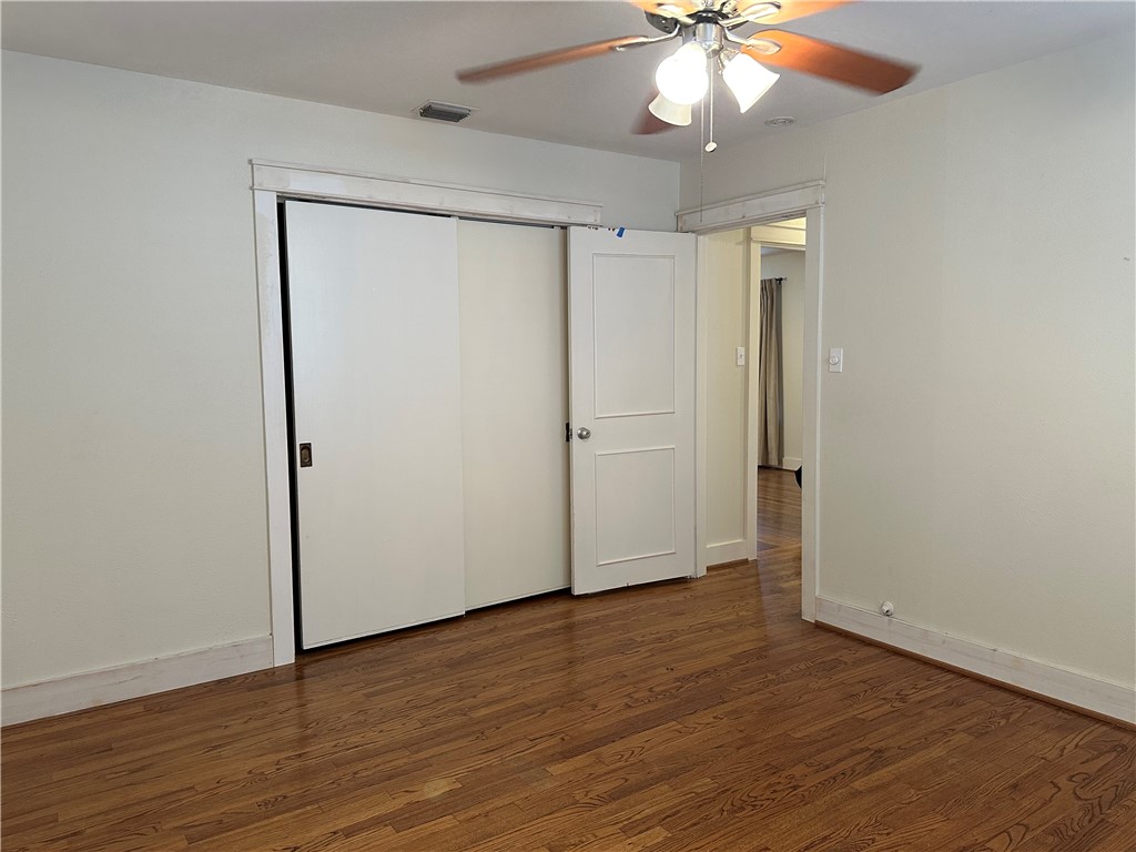 3237 Lawnview Street Corpus Christi, TX 78404 - Photo 22 of 22 an empty room with wooden floor and a ceiling fan