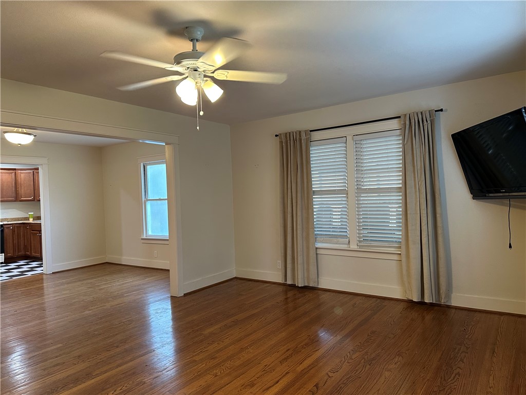 3237 Lawnview Street Corpus Christi, TX 78404 - Photo 3 of 22 a view of an empty room with wooden floor and a window