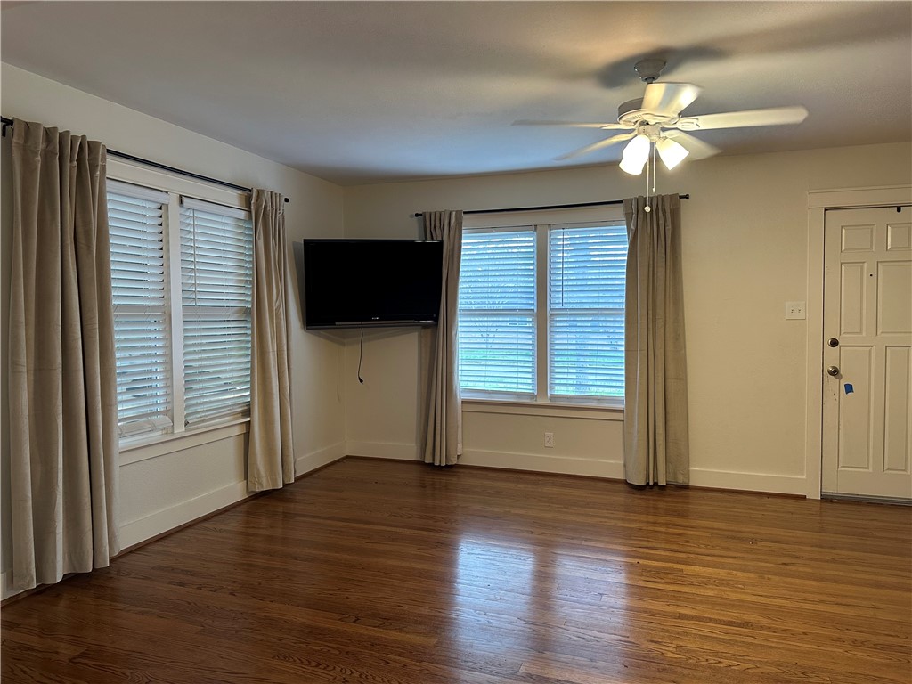 3237 Lawnview Street Corpus Christi, TX 78404 - Photo 4 of 22 a view of a livingroom with wooden floor and a ceiling fan